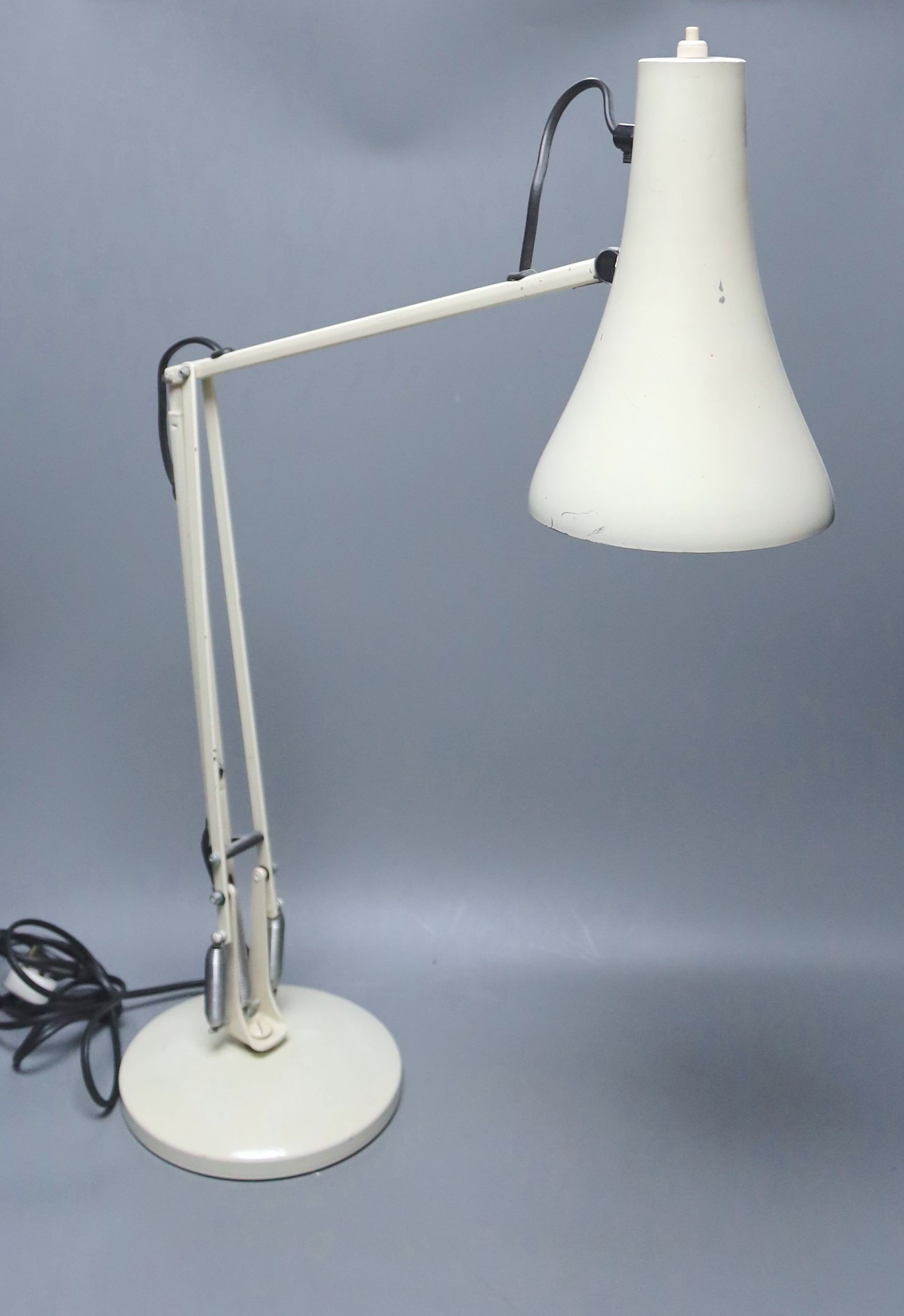 A cream anglepoise lamp, 83 cms high.